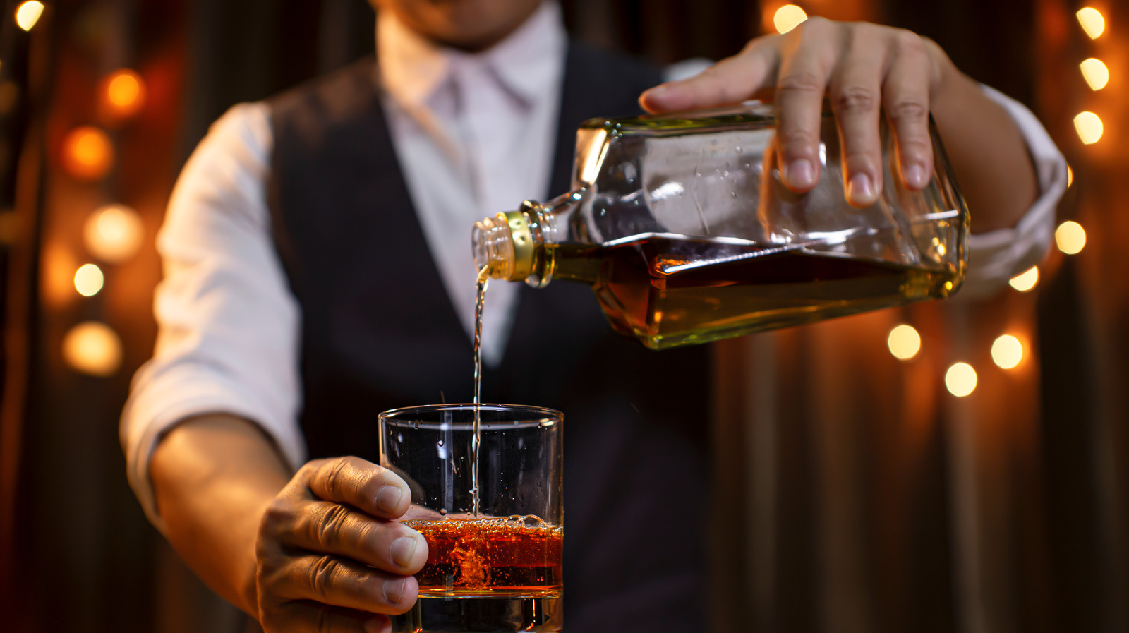 Whisky Bourbon On Ice Being Prepared By A Professional Bartender Pouting  The Drink Into Ornamental Glasses High-Res Stock Photo - Getty Images