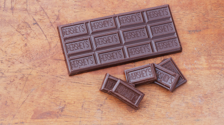 Bar of Hershey chocolate against a wooden background 