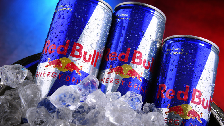 Cans of Red Bull energy drink on ice