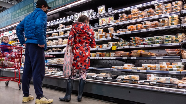 Family shopping in prepared food aisle 