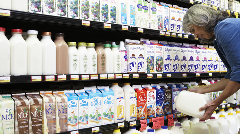 Woman shopping in milk aisle 