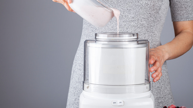 Woman pouring ice cream base into a machine