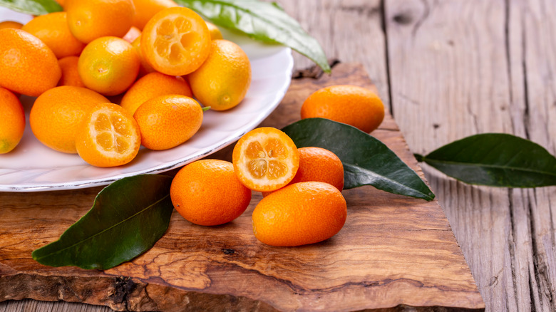 kumquats on wooden board