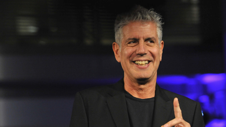 Anthony Bourdain smiling and pointing