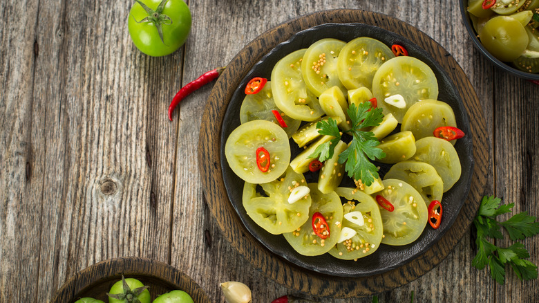 pickled green tomatoes on table