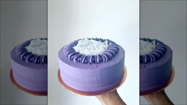 Hand holding ube macapuno cake