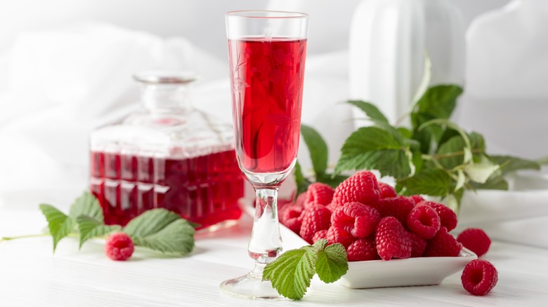 glass of framboise liqueur with fresh raspberries