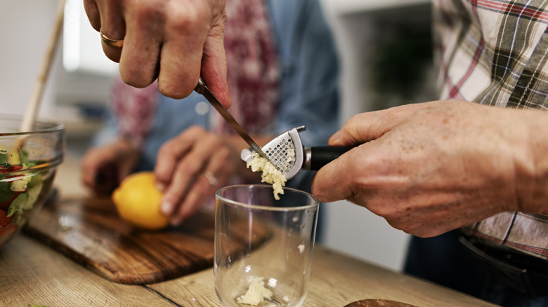 mincing garlic with garlic press