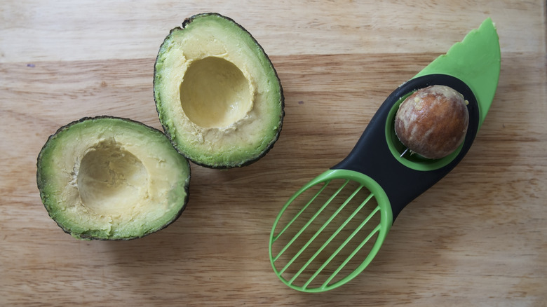 avocado with avocado slicing tool