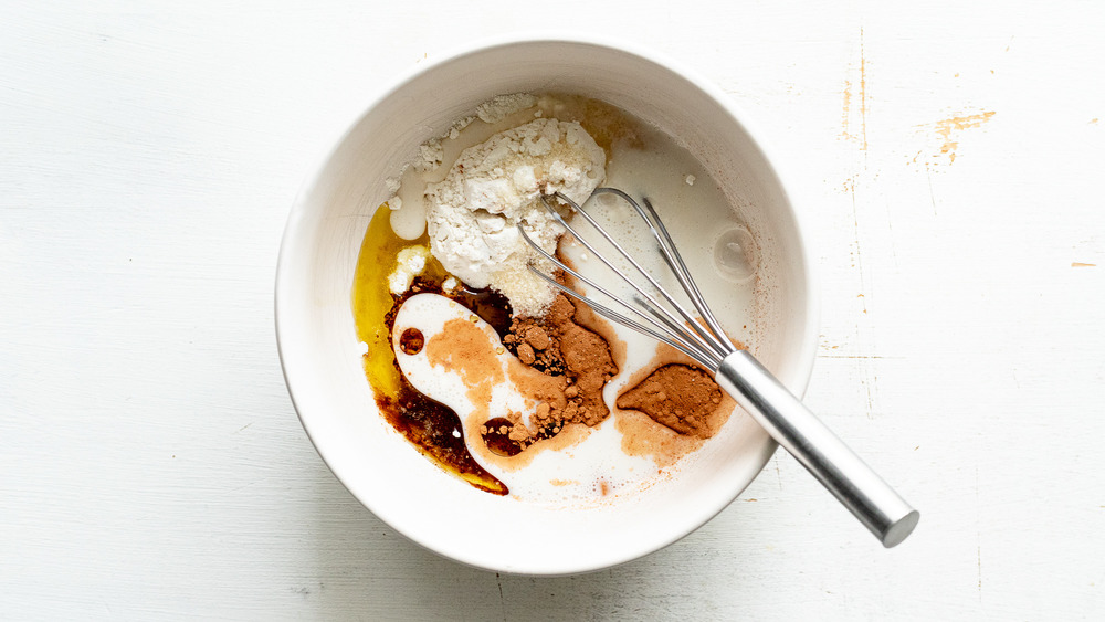 mug cake ingredients with whisk in bowl