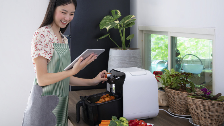 woman cooking with air fryer