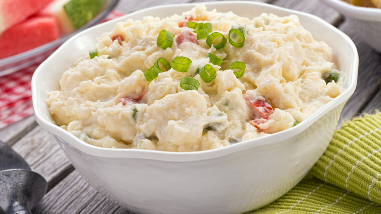 Potato salad with mayo topped with scallion