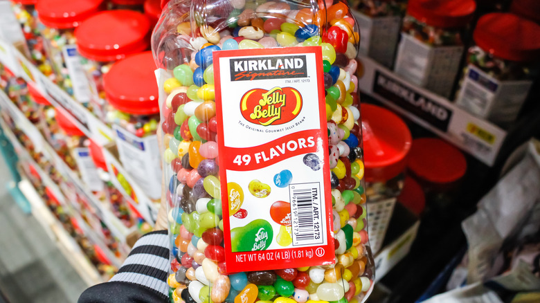 Hand holding Kirkland jelly beans container