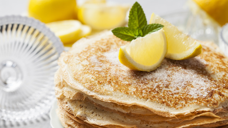 Stack of crepes with lemon and sugar on top