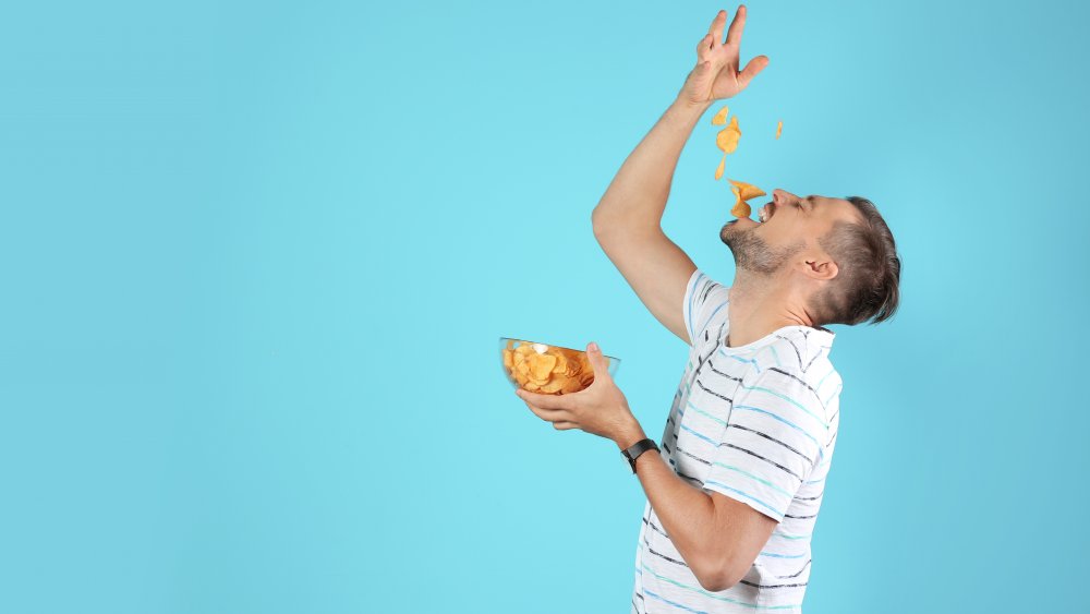 Man eating potato chips