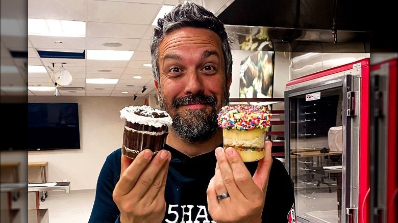 Fabio Viviani holding jarred desserts