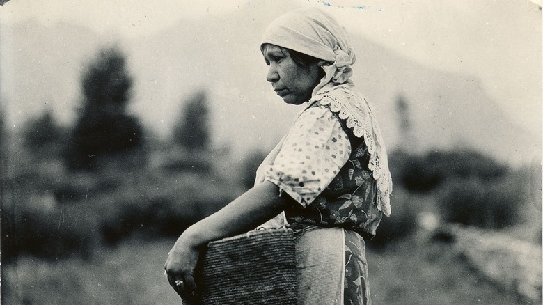 indigenous woman holding basket