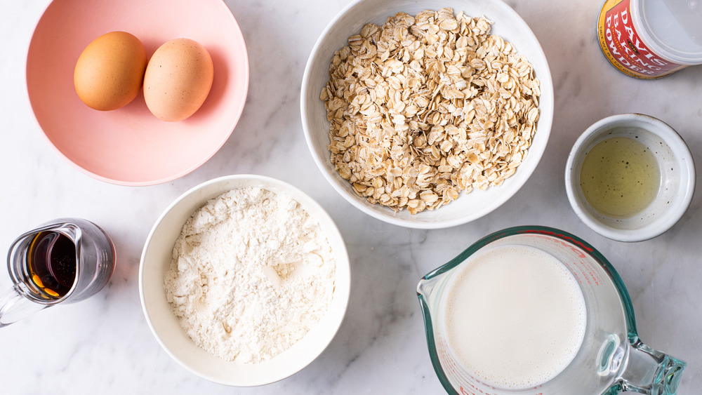 Ingredients gathered on a marble counter to make oatmeal pancakes