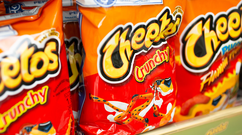 Bags of Cheetos on a shelf.