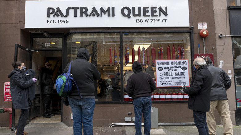 People standing outside Pastrami Queen 