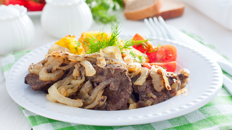 plate of beef liver with onions