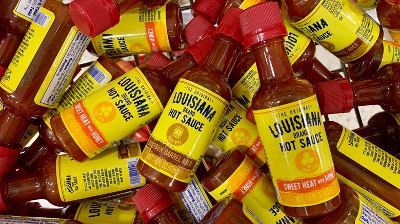 Pile of mini Louisiana Hot Sauce bottles