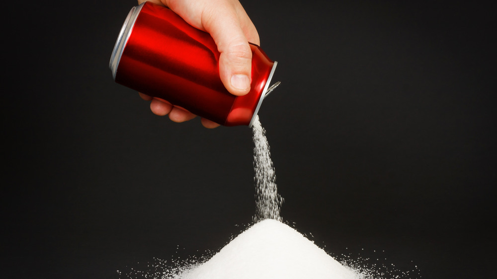 Soda can pours sugar