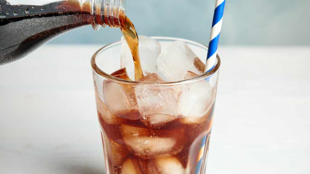 Pouring soda over ice