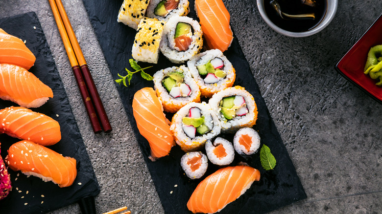 Sushi on black slate and gray concrete countertop