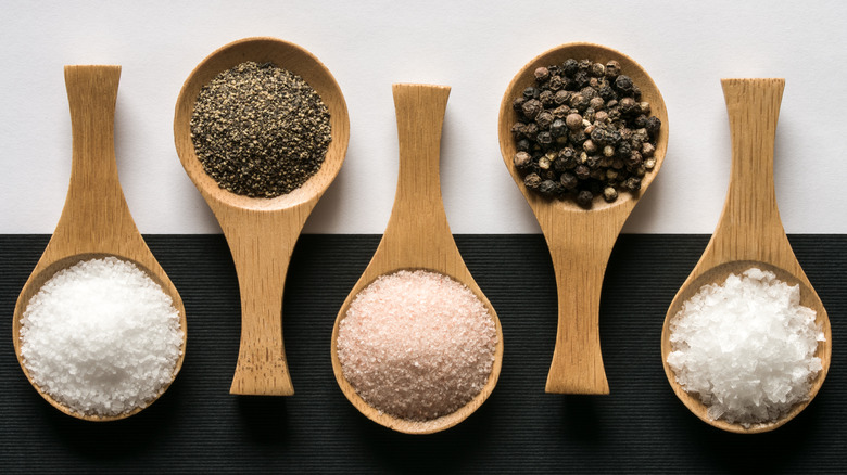 Wooden spoons filled with salt and pepper