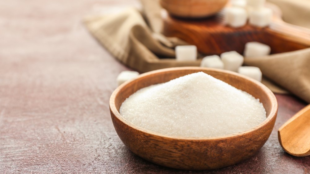 Wooden bowl full of sugar