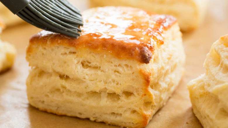 Brushing butter on biscuits with silicone brush