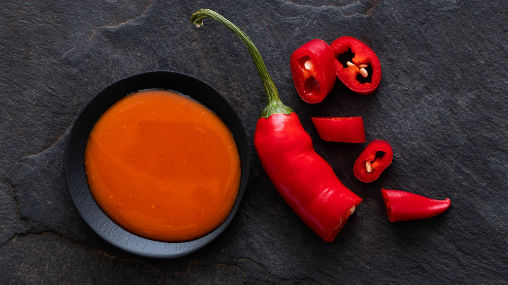 Piri-piri sauce in a bowl along with a red pepper