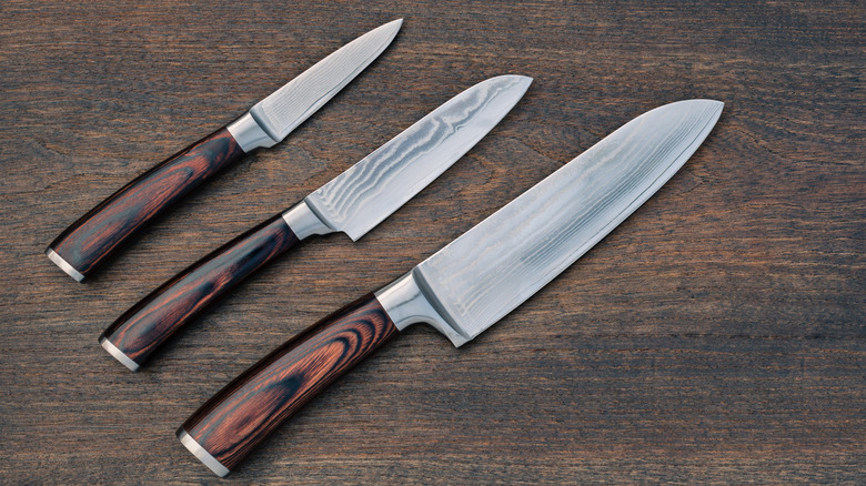 Three knives with polished wood handles