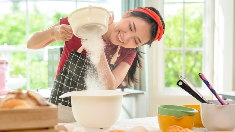 woman sifting flour