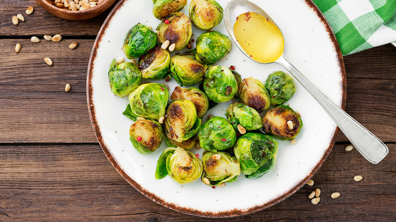 Brussels sprouts with spoon of oil