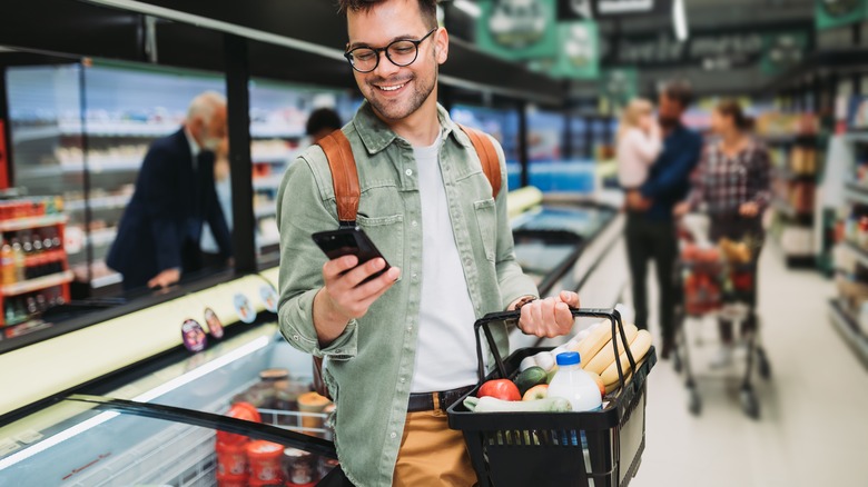 Man happily grocery shopping