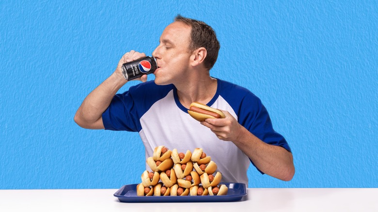 Joey Chestnut washing down hot dogs with Pepsi