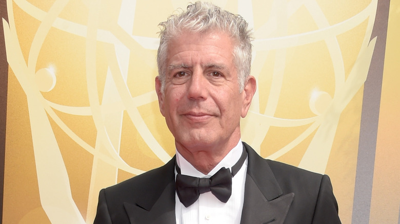 Anthony Bourdain wears a suit and bowtie