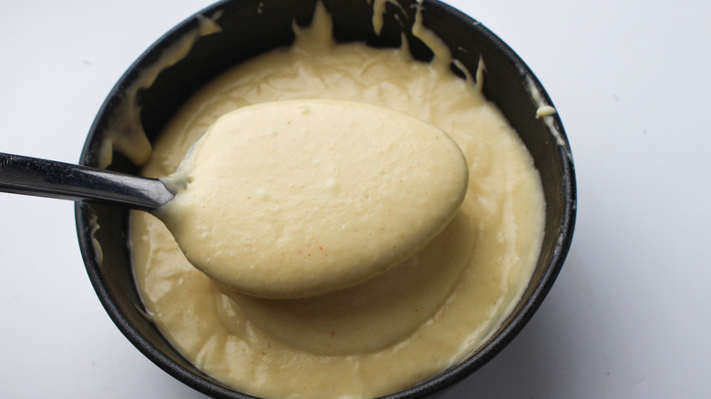 cheese sauce in spoon
