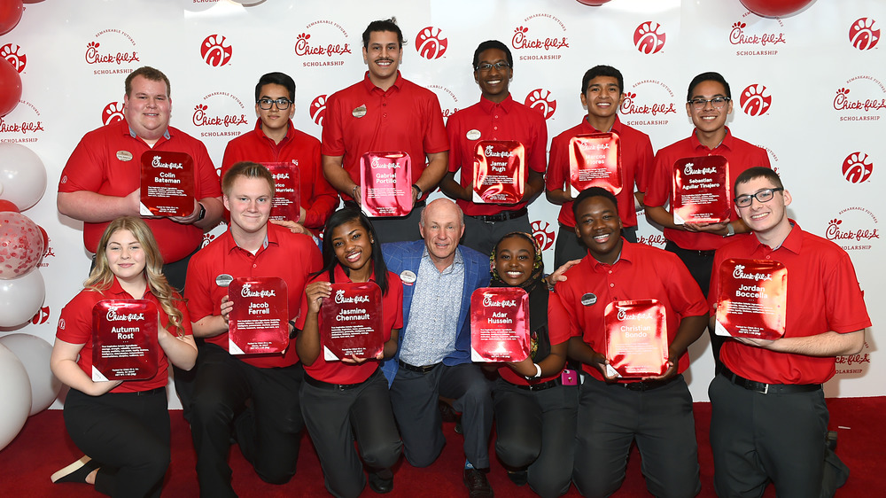 A Chick-fil-A team surrounding Dan Cathy. 