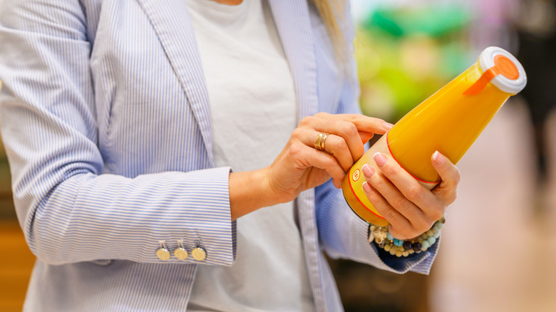 Woman looking at drink label