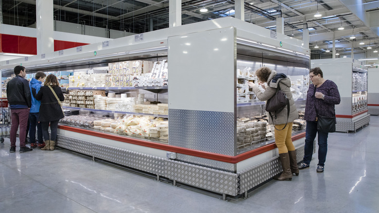 Customers browsing Costco cheese section