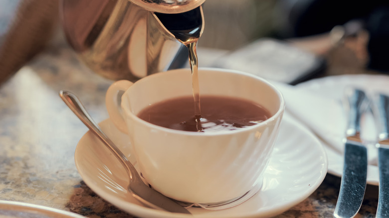 Pouring tea into mug