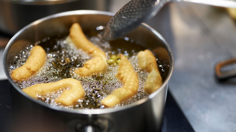 Churros being fried in oil