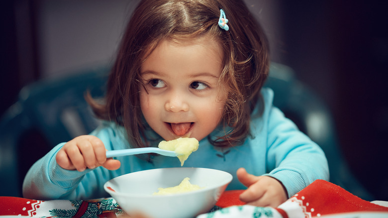 Child eating mashed potatoes