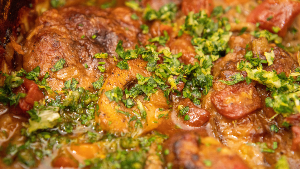 ossobuco veal shanks in braising liquid with herbs