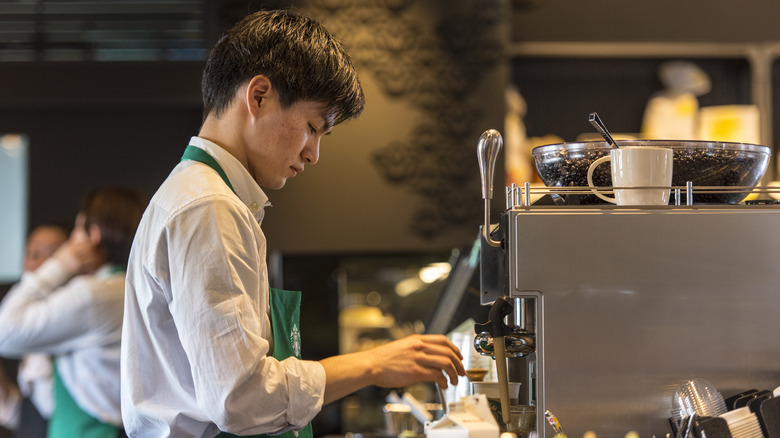 Starbucks barista makes a drink