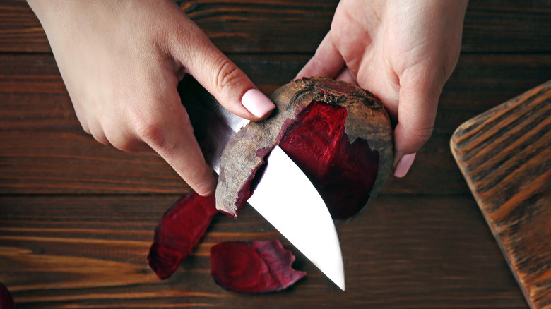 Person peeling a beet