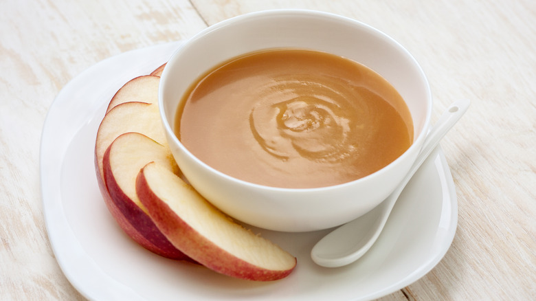 Caramel sauce in bowl with apple slices